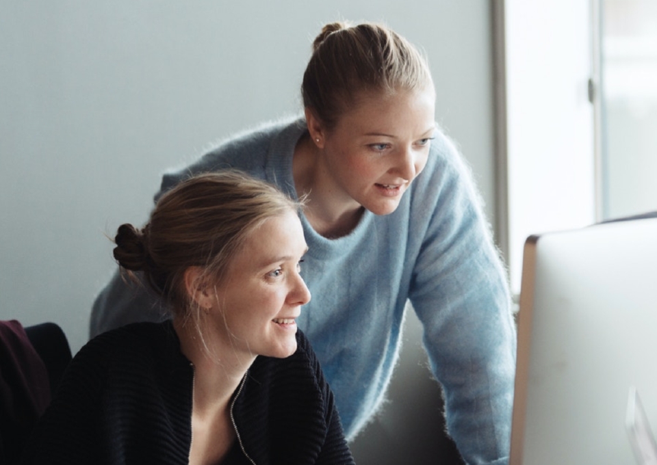 Two women looking at screen